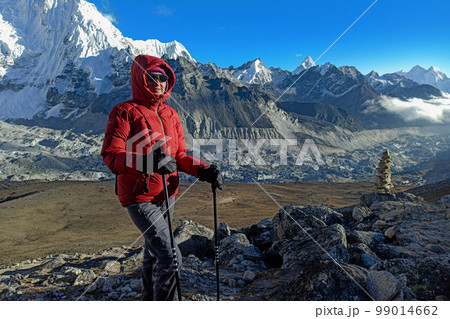 Hiker woman posing with mountains at background 99014662