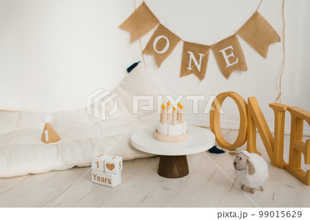 Wooden toy birthday cake. Photo zone of the celebration of the first year of the baby Wooden toy birthday cake. Photo zone of the celebration of the first year of the baby 99015629