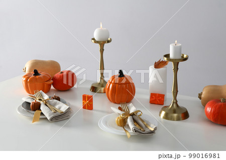 Concept of Thanksgiving day, Autumn table setting on white table Concept of Thanksgiving day, Autumn table setting on white table 99016981