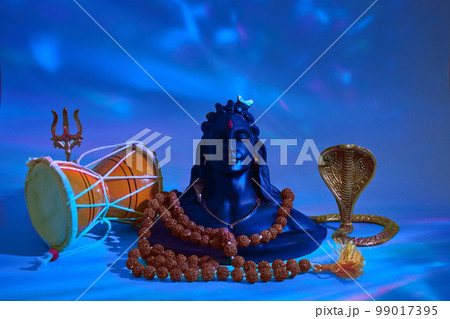 Shivaratri background with Shivas trident, Pellet Drum Damroo musical instrument ans snake . Maha Shivratri festval Shivaratri background with Shivas trident, Pellet Drum Damroo musical instrument ans snake . Maha Shivratri festval 99017395