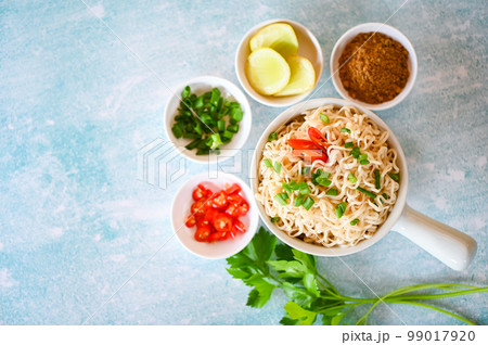 instant noodles cooking tasty eating with bowl, noodles bowl with vegetable spring onion lemon lime lettuce celery and chili on table food, noodle soup instant noodles cooking tasty eating with bowl, noodles bowl with vegetable spring onion lemon lime lettuce celery and chili on table food, noodle soup 99017920