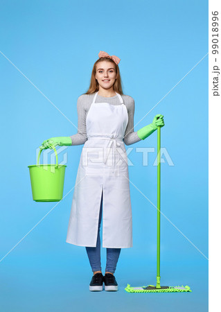 woman in rubber gloves and cleaner apron washing floor with mop 99018996