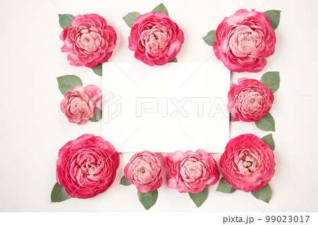 Love letter. white card with pink paper envelope mock up. Petals of flowers, roses and ranunculus. Valentine's day romantic background . Space for text. 99023017
