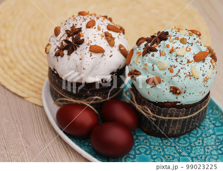 Easter eggs and cakes with icing, nuts and anise stars 99023225