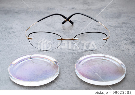 New lenses and frame for eyeglasses production lying on table in optic New lenses and frame for eyeglasses production lying on table in optic 99025382