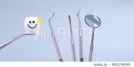 Dental tools and model of teeth on a blue background. Dental care concept. Invisible braces 99028690