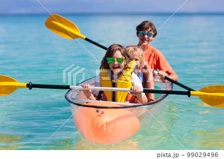 Kids kayaking in ocean. Family in kayak in tropical sea 99029496