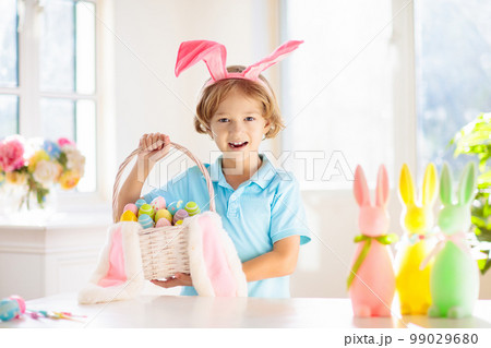 Kids on Easter egg hunt. Children dye eggs. Kids on Easter egg hunt. Children dye eggs. 99029680