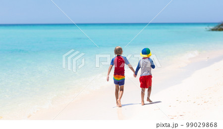 Kids playing on beach. Children play at sea. 99029868