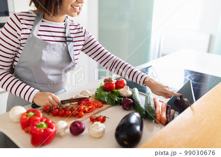Cropped of woman cooking at home, using digital tablet, mockup 99030676