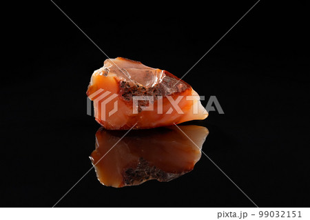 Carnelian Uncut Gem Stone on Black Background 99032151