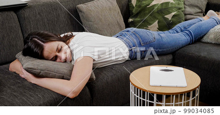 Young woman is sleeping on the couch Young woman is sleeping on the couch 99034085