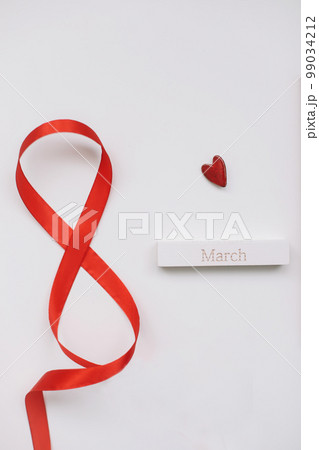 Eight made of red ribbon. 8 March greeting card template. International Women's day background, banner, poster or brochure Eight made of red ribbon. 8 March greeting card template. International Women's day background, banner, poster or brochure 99034212