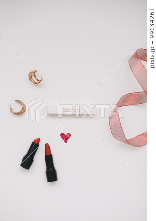 Concept Women's Day, Valentines Day, March 8. Lipsticks, cosmetic makeup products and accessories flatlay top view.  99034261