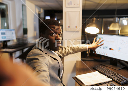 Executive manager discussing financial growth report with remote colleagues during online videocall meeting in startup office. Advisor agent working over hours at company strategy. Business concept Executive manager discussing financial growth report with remote colleagues during online videocall meeting in startup office. Advisor agent working over hours at company strategy. Business concept 99034610