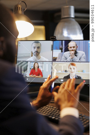 Advisor agent explaining financial strategy to remote team during online videocall meeting, discussing company profit growth report. Diverse business people working overhours at marketing project Advisor agent explaining financial strategy to remote team during online videocall meeting, discussing company profit growth report. Diverse business people working overhours at marketing project 99034611