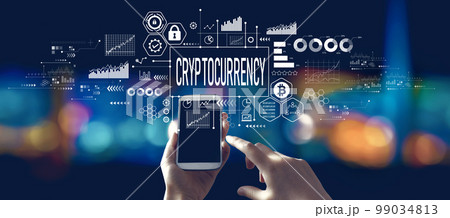 Cryptocurrency theme with person using a smartphone at night 99034813