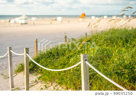 Pathway to the beach in Miami Florida with ocean background Pathway to the beach in Miami Florida with ocean background 99035250
