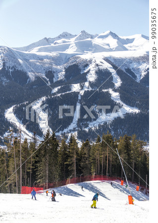 Skiing high up in the mountains in Russia 99035675