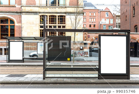 Blank billboard on roadside in european town 99035746