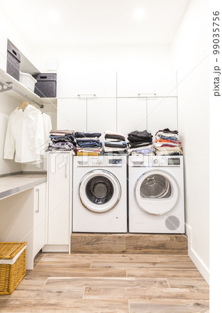 Stacks of clean clothes in utility room Stacks of clean clothes in utility room 99035756
