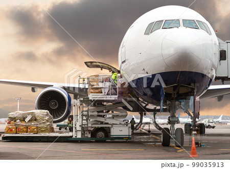 loading cargo into the aircraft before departure with nice sky 99035913