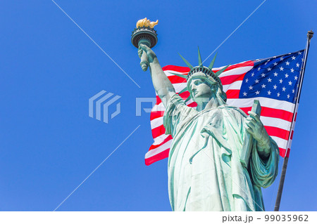 Statue of Liberty with a large american flag and New York skyline in the background 99035962