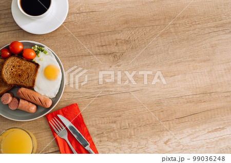 English breakfast with black coffee and orange juice on the wooden table with copy space 99036248