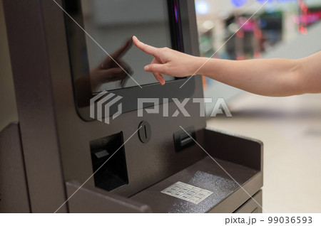 Faceless woman using touchscreen ATM. Faceless woman using touchscreen ATM. 99036593