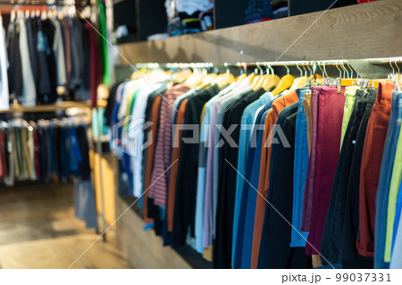 Stand with various clothes in clothing boutique 99037331