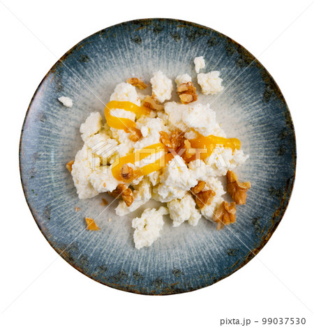 Mato served with honey and walnut on plate Mato served with honey and walnut on plate 99037530