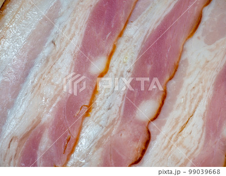 Curvy cut folded into rolls. Pork on a kitchen board . Still life of meat. Pork belly appetizer. Bacon background Curvy cut folded into rolls. Pork on a kitchen board . Still life of meat. Pork belly appetizer. Bacon background 99039668