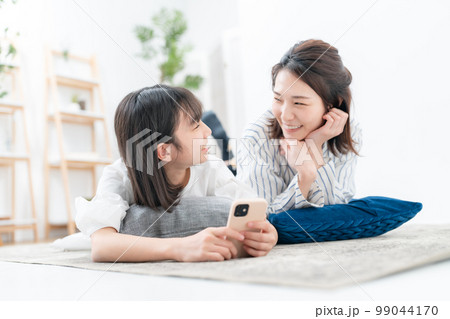 寝そべる親子 スマホ 寝そべる親子 スマホ 99044170