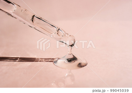 A drop of cosmetic oil falls from the pipette 99045039