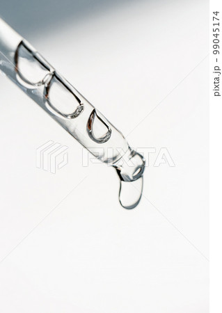 A drop of cosmetic oil falls from the pipette A drop of cosmetic oil falls from the pipette 99045174