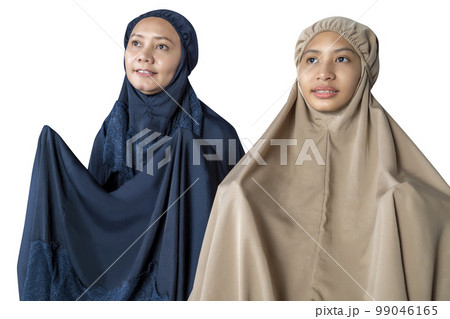 Asian Muslim mother and daughter in a hijab raised hands and praying Asian Muslim mother and daughter in a hijab raised hands and praying 99046165