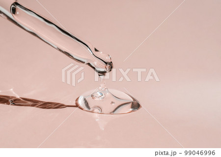 A drop of cosmetic oil falls from the pipette A drop of cosmetic oil falls from the pipette 99046996