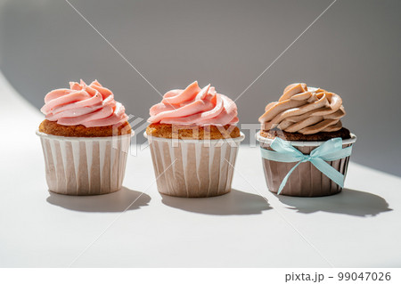 Cupcakes on a white sunny background with a shadow. Cupcakes on a white sunny background with a shadow. 99047026