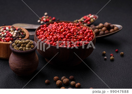 Composition, concept, consisting of several types of different colors of allspice in bowls and spoons Composition, concept, consisting of several types of different colors of allspice in bowls and spoons 99047688