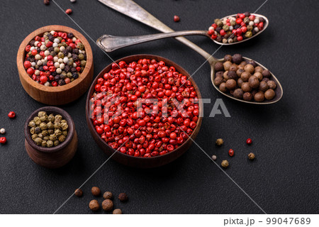 Composition, concept, consisting of several types of different colors of allspice in bowls and spoons Composition, concept, consisting of several types of different colors of allspice in bowls and spoons 99047689