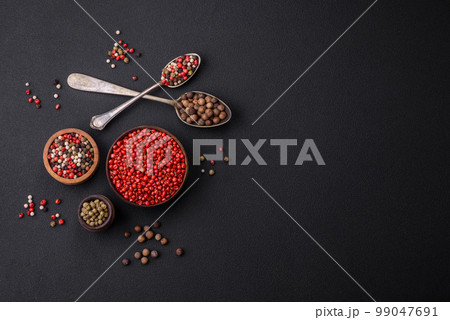 Composition, concept, consisting of several types of different colors of allspice in bowls and spoons Composition, concept, consisting of several types of different colors of allspice in bowls and spoons 99047691