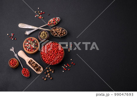 Composition, concept, consisting of several types of different colors of allspice in bowls and spoons Composition, concept, consisting of several types of different colors of allspice in bowls and spoons 99047693