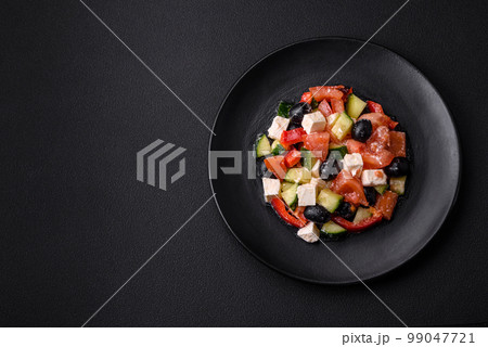 Delicious fresh Greek salad with olives, tomatoes, cucumbers and feta cheese Delicious fresh Greek salad with olives, tomatoes, cucumbers and feta cheese 99047721