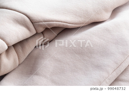 Warm gray sweatshirt, macro. Decorative 99048732