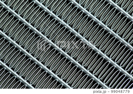 Texture of a honeycomb of an automotive aluminum car cooling radiator, close-up. Texture of a honeycomb of an automotive aluminum car cooling radiator, close-up. 99048779
