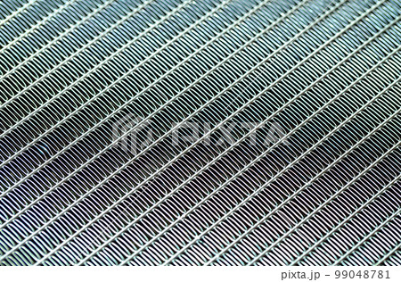 Texture of a honeycomb of an automotive aluminum car cooling radiator, close-up. Texture of a honeycomb of an automotive aluminum car cooling radiator, close-up. 99048781