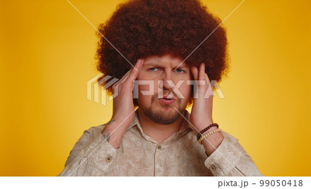 Sick man rubbing temples to cure headache problem, suffering from tension and migaine, stress, pain Sick man rubbing temples to cure headache problem, suffering from tension and migaine, stress, pain 99050418
