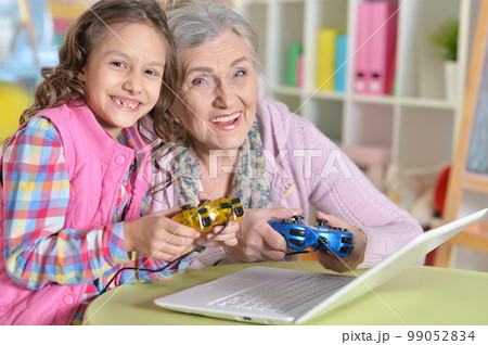 Cute girl and grandmother playing Cute girl and grandmother playing 99052834