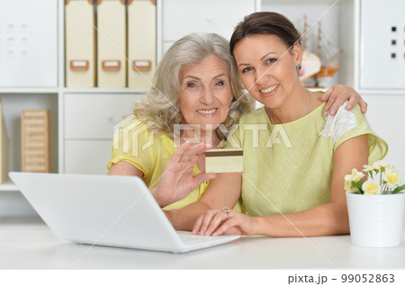 Beautiful women using laptop at home shopping online Beautiful women using laptop at home shopping online 99052863