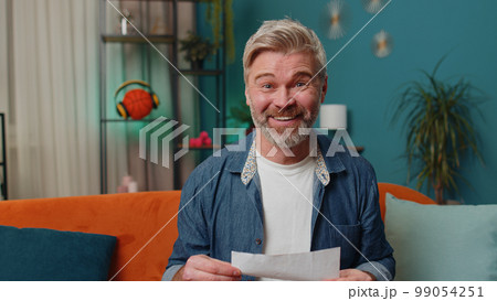 Old man open envelope letter reads it feel happy, career growth advance promotion, bank loan approve 99054251